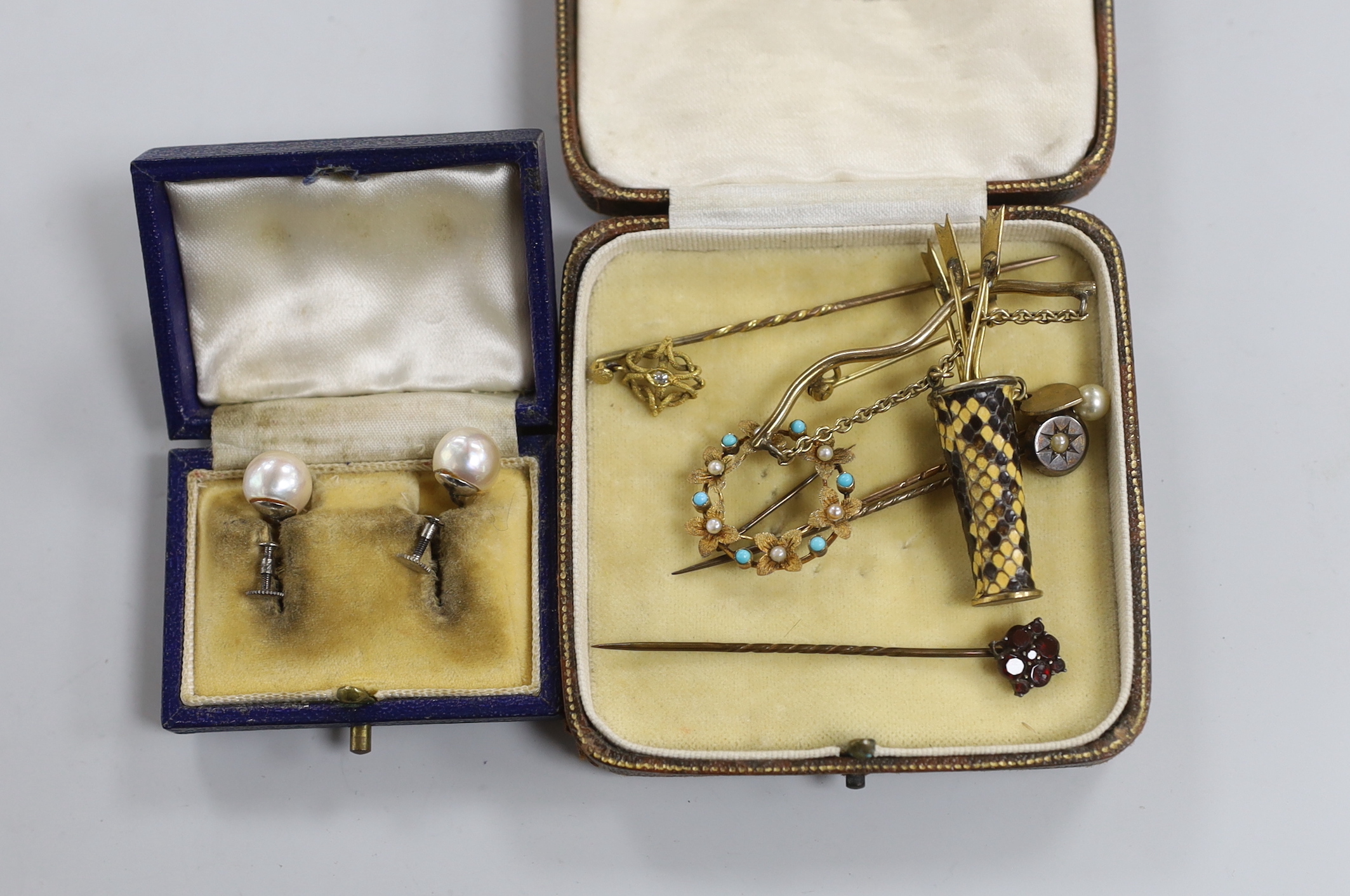 A pair of 9ct white metal and cultured pearl ear clips, a circular brooch, arrow and quiver brooch and four stick pins